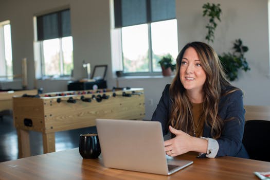 an office worker smiling at their plant