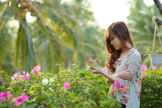 a person planting flowers in their garden