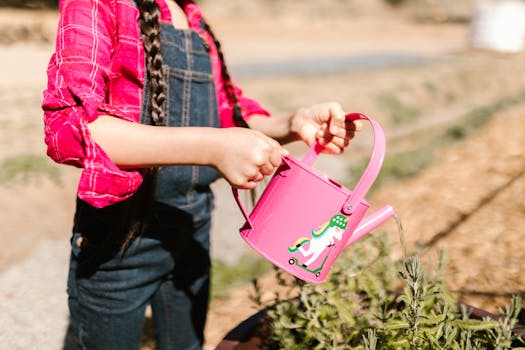 a person watering plants in a sunny garden